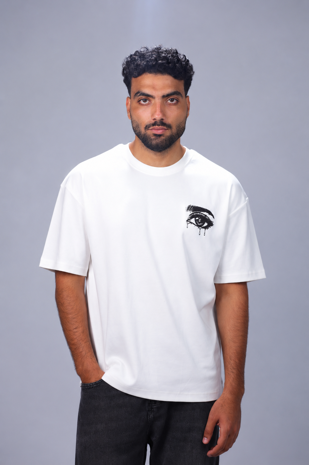 oversized heavyweight cotton T-shirt featuring an eye graphic on the front and bold street-inspired typography on the back.
